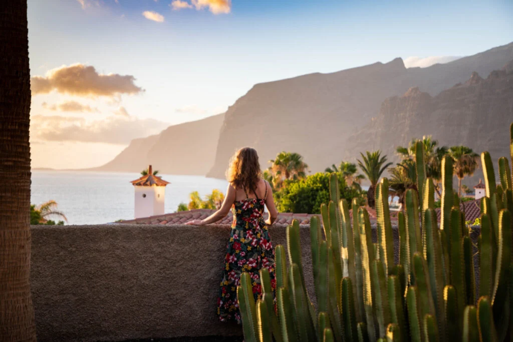 woman looking at sunset over the ocean in Tenerife Canary islands