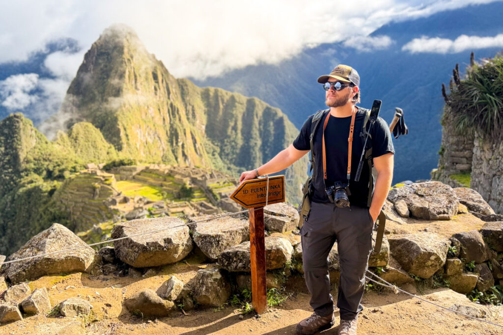 Tyler Fox standing in front of Machu Picchu after hiking the Inca Trail