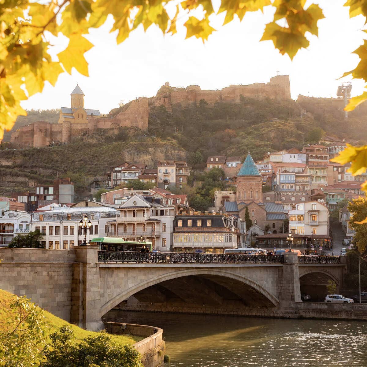 Tbilisi Old Town And Mtkvari River Framed By Autumn Leaves, Georgia