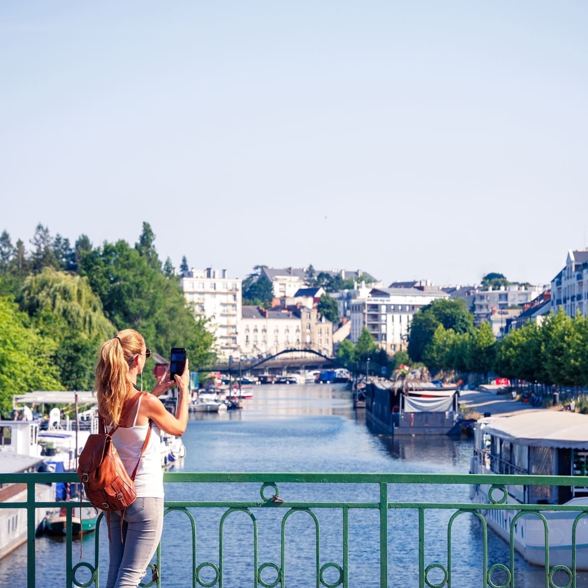 A Female Tourist Photographing The Riverside In Nantes, France