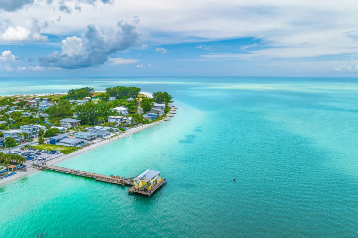 An aerial view of a fishing pier on Holmes Beach in Anna Maria Island Florida.