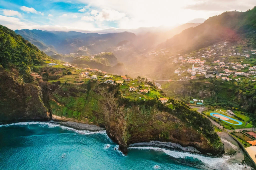 Aerial view of rough ocean with huge cliff and waves, volcanic beach in Guindaste viewpoint in faial, Madeira, Portugal