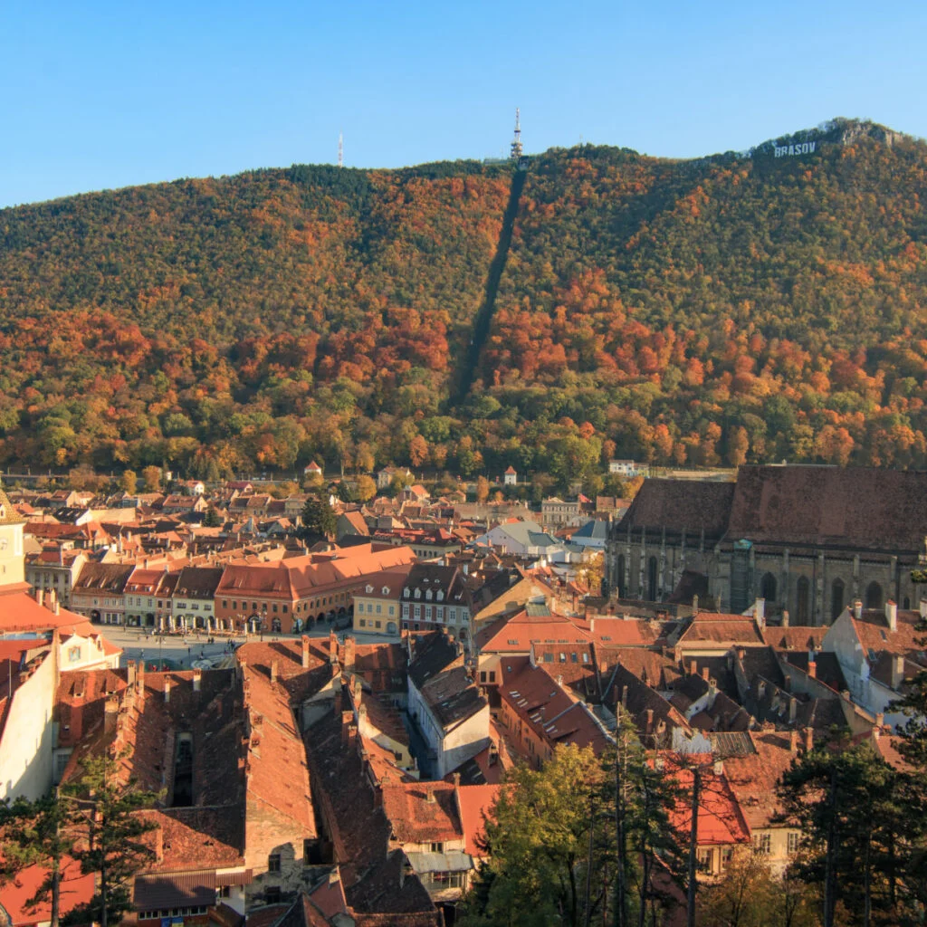 Europe, Romania, Brasov. City signage. Poarta Schei district. Looking-out over forested park and hill side near the Tampa Mountain area.