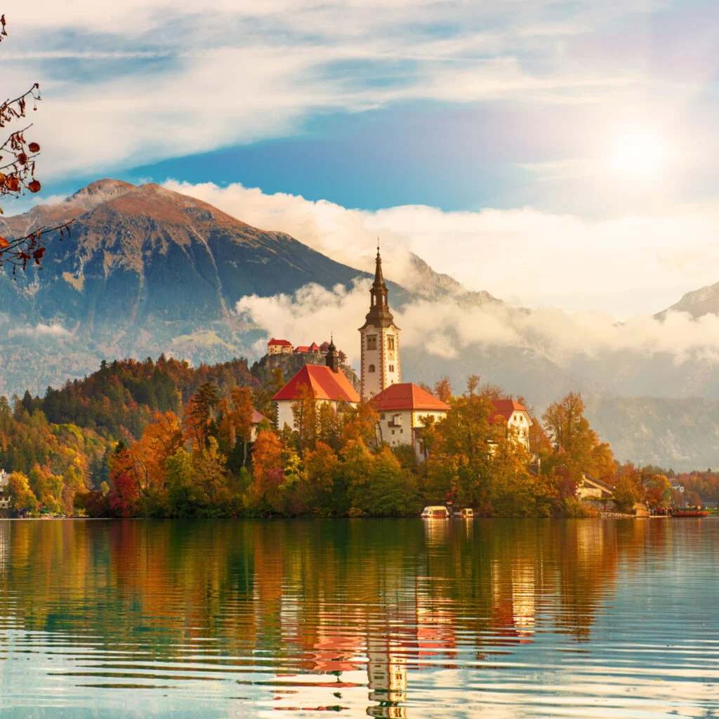 Church of Assumption in Lake Bled, Slovenia with blue sky and clouds in the autumn