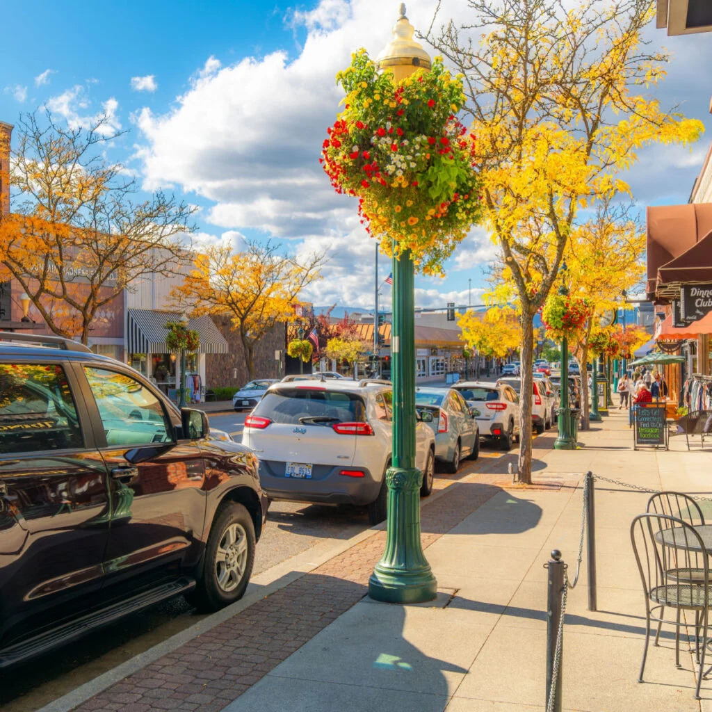 Shops and sidewalk cafes on Sherman Avenue in the lakeside small town of Coeur dAlene, Idaho at autumn in the North Idaho panhandle region.