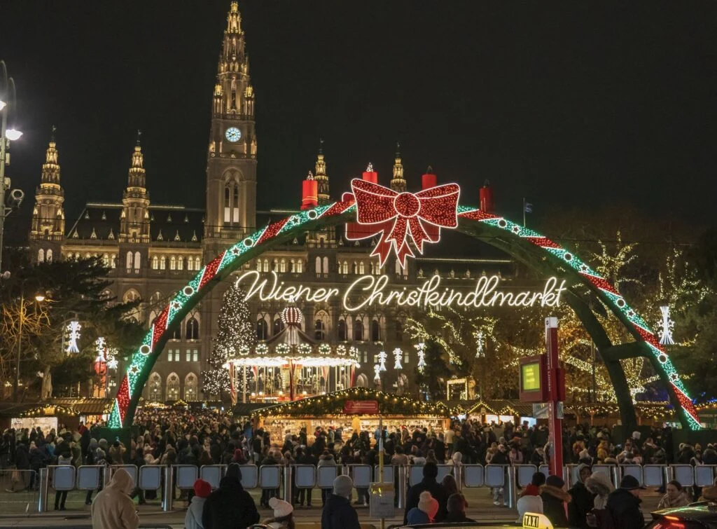 Evening view of Rathaus Park and Vienna City Hall. Christmas market