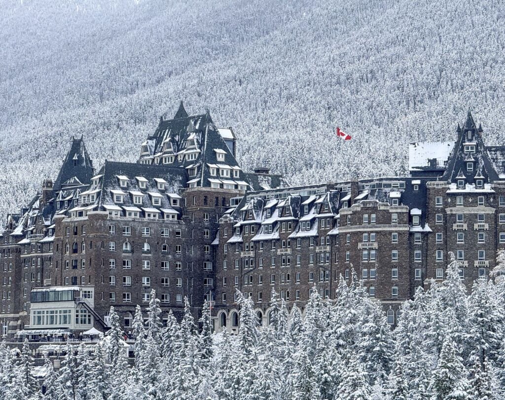 stone castle hotel with its signature green roofs blanketed in fresh snow,