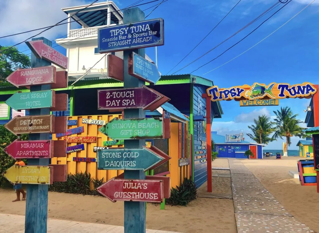 Colorful street sign on the beachfront Sidewalk outside the Tipsy Tuna bar.