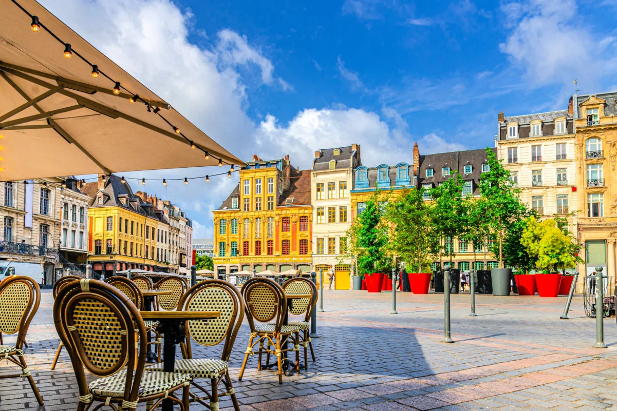 La Grand Place square in Lille city center, Flemish mannerist architecture style buildings, trees in pots, tables and chairs of street restaurant, French Flanders, Nord department, Northern France