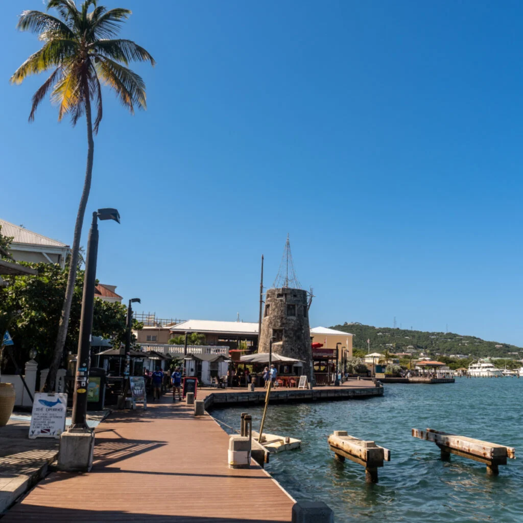 Harbor waterfront Windmill on Christiansted boardwalk. Relic of sugarcane era on Saint Croix. Boardwalk with dive shops, restaurants and bars