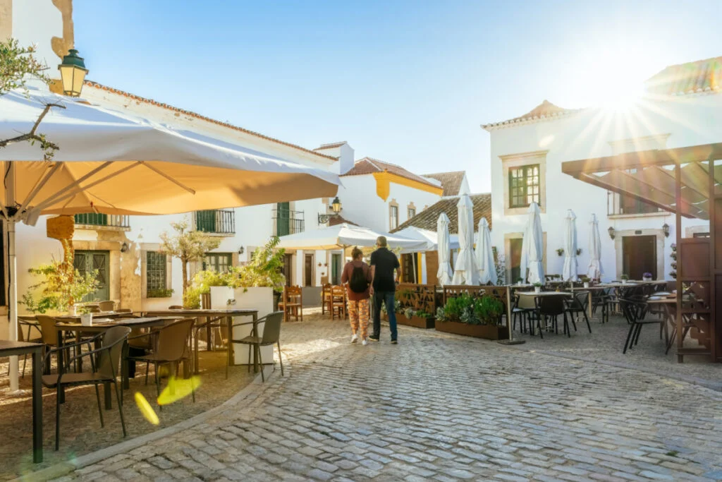 A tourist couple visiting Faro old town street